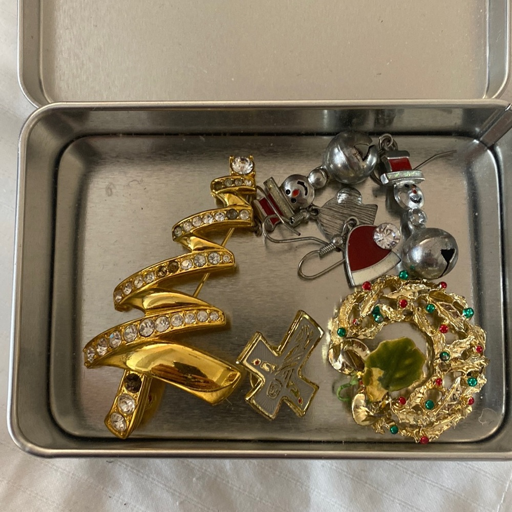 Christmas pins and earrings, assorted styles and a metal tin